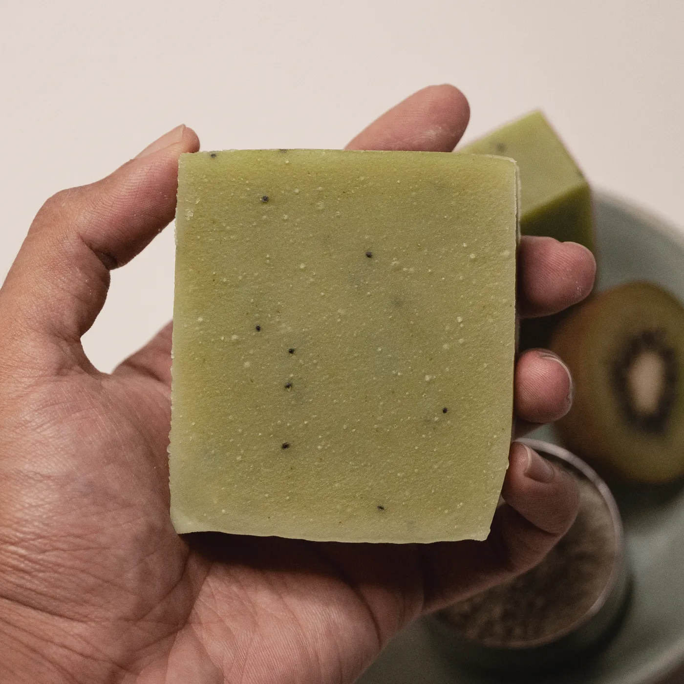 A bar of Kiwi soap held in a hand